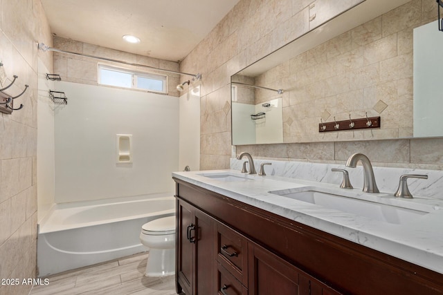 8051 W Mariposa Dr, Phoenix, AZ 85033 - bathroom featuring tile walls, toilet, shower / bath combination, and double vanity