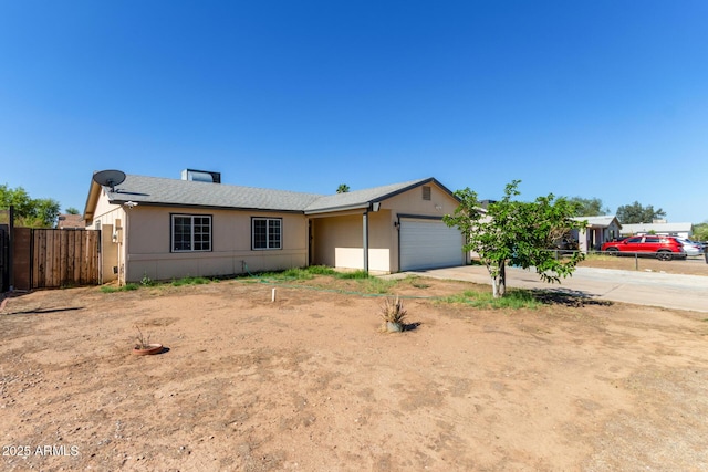 8051 W Mariposa Dr, Phoenix, AZ 85033 - view of front facade featuring an attached garage, driveway, and stucco siding