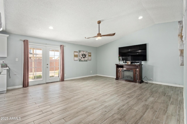8051 W Mariposa Dr, Phoenix, AZ 85033 - unfurnished living room with ceiling fan, light wood-style floors, a textured ceiling, french doors, and vaulted ceiling
