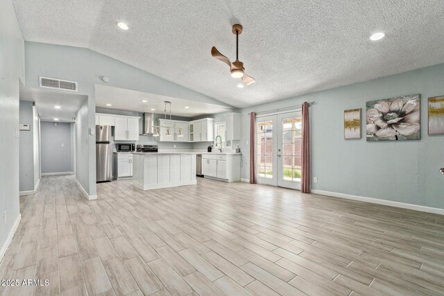 8051 W Mariposa Dr, Phoenix, AZ 85033 - unfurnished living room with ceiling fan, a sink, vaulted ceiling, light wood-style floors, and baseboards