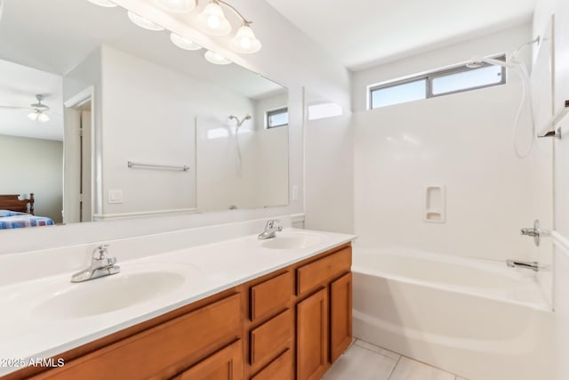 bathroom with shower / bathing tub combination, tile patterned flooring, ceiling fan, and vanity