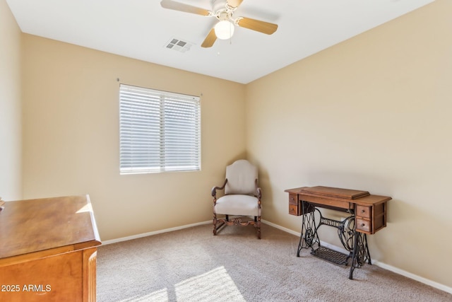 living area with light carpet and ceiling fan