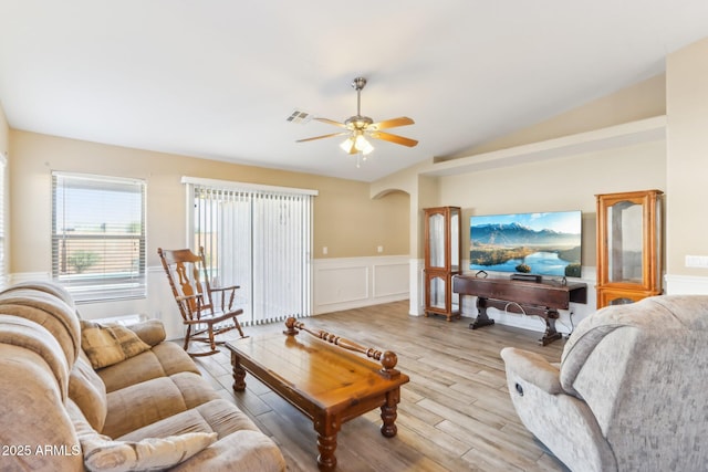 living room with light wood-type flooring, ceiling fan, and vaulted ceiling