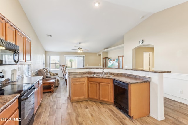 kitchen featuring sink, lofted ceiling, ceiling fan, light hardwood / wood-style flooring, and black appliances