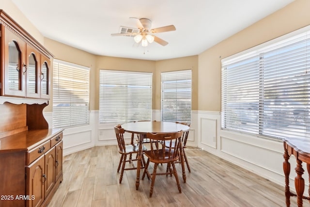 dining area with light hardwood / wood-style floors and ceiling fan