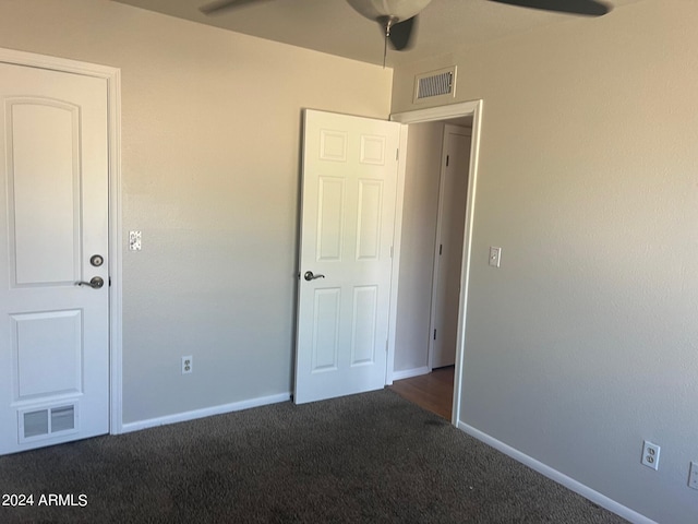 unfurnished bedroom featuring dark colored carpet