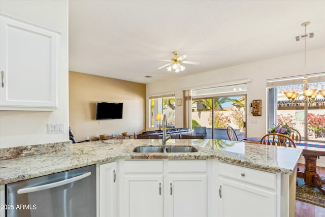 kitchen featuring visible vents, a sink, stainless steel dishwasher, and white cabinetry