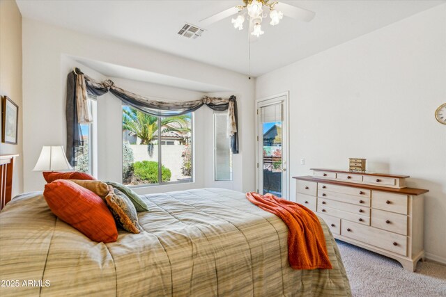 bedroom with access to outside, carpet floors, visible vents, and a ceiling fan