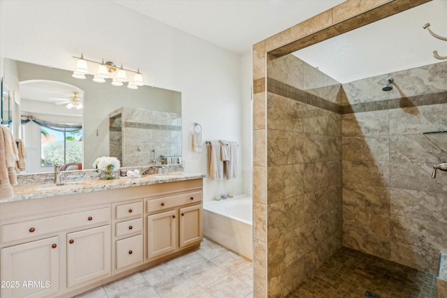 bathroom featuring ceiling fan, vanity, plus walk in shower, and tile patterned flooring