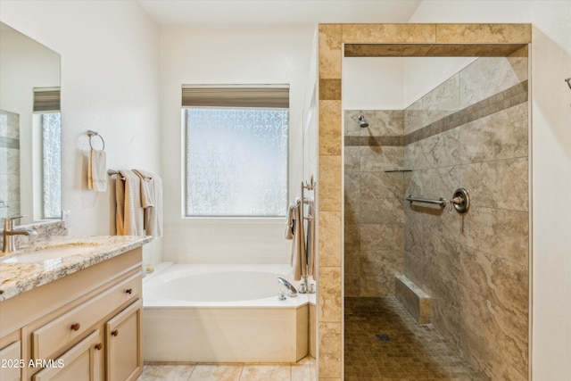 bathroom with vanity, tile patterned flooring, and plus walk in shower