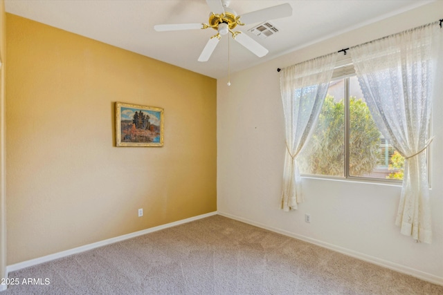 unfurnished room with carpet, a healthy amount of sunlight, visible vents, and baseboards