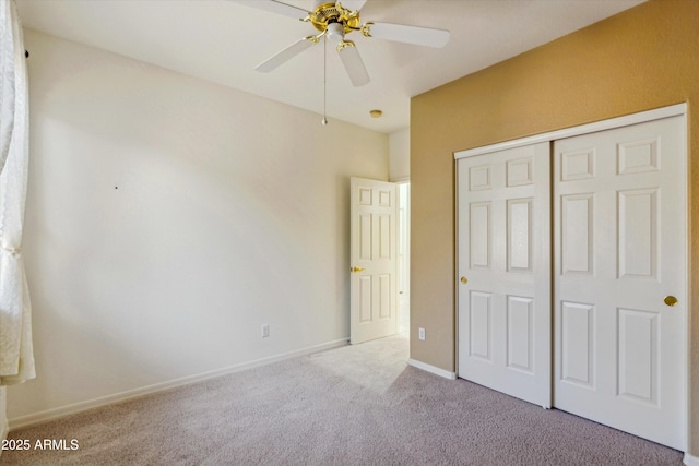 unfurnished bedroom featuring light colored carpet, ceiling fan, and a closet