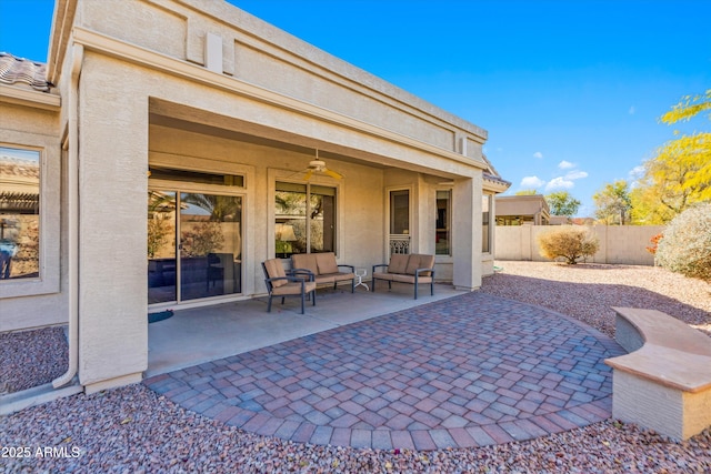 view of patio featuring fence, an outdoor hangout area, and a ceiling fan