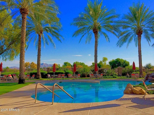 view of swimming pool with a mountain view