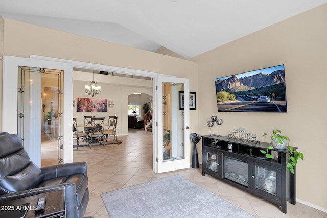 1292 N Renee Ave, Gilbert, AZ 85234 - living area featuring arched walkways, light tile patterned floors, lofted ceiling, a chandelier, and french doors