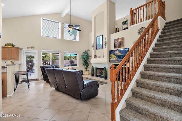 1292 N Renee Ave, Gilbert, AZ 85234 - living room with light tile patterned floors, beam ceiling, ceiling fan, stairway, and high vaulted ceiling