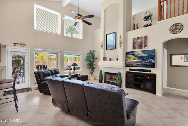 1292 N Renee Ave, Gilbert, AZ 85234 - living room with high vaulted ceiling, light tile patterned floors, a ceiling fan, a tiled fireplace, and beam ceiling
