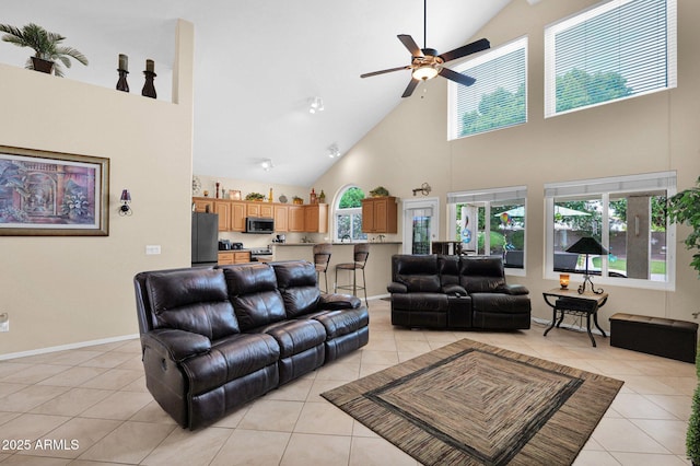 1292 N Renee Ave, Gilbert, AZ 85234 - living area with high vaulted ceiling, light tile patterned floors, ceiling fan, and baseboards
