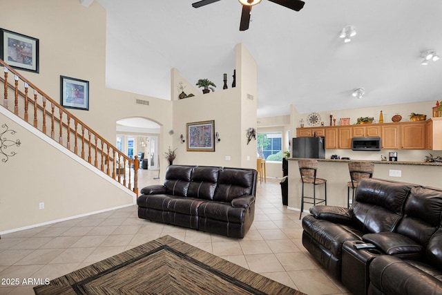 1292 N Renee Ave, Gilbert, AZ 85234 - living room featuring light tile patterned floors, stairway, ceiling fan, baseboards, and arched walkways