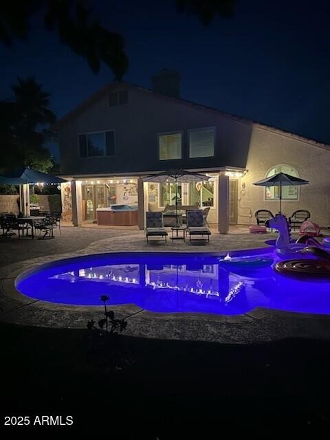 1292 N Renee Ave, Gilbert, AZ 85234 - pool at night featuring an outdoor hot tub, a patio, and an outdoor pool