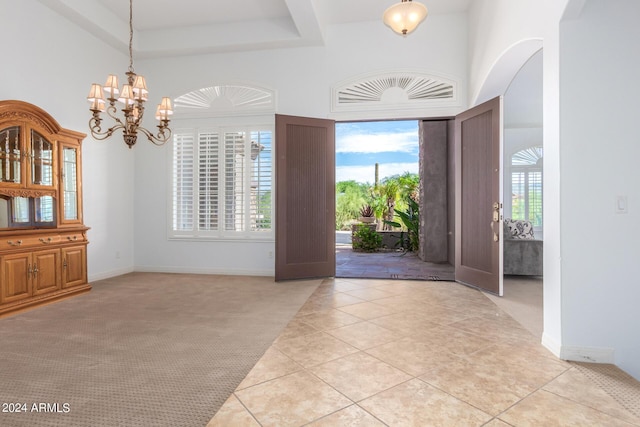 9845 E Inglewood St, Mesa, AZ 85207 - entryway with light tile patterned floors, a raised ceiling, a towering ceiling, light carpet, and a chandelier