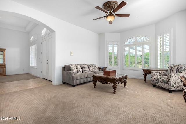 9845 E Inglewood St, Mesa, AZ 85207 - carpeted living room with arched walkways, tile patterned flooring, a ceiling fan, and baseboards