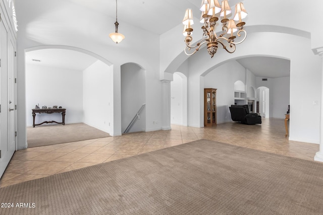 9845 E Inglewood St, Mesa, AZ 85207 - spare room featuring a high ceiling, carpet flooring, visible vents, tile patterned floors, and an inviting chandelier