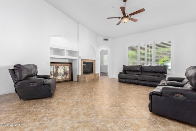 9845 E Inglewood St, Mesa, AZ 85207 - living area featuring built in features, a fireplace, light tile patterned floors, visible vents, and high vaulted ceiling