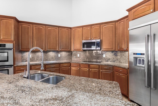 9845 E Inglewood St, Mesa, AZ 85207 - kitchen with stainless steel appliances, dark stone countertops, a sink, and decorative backsplash