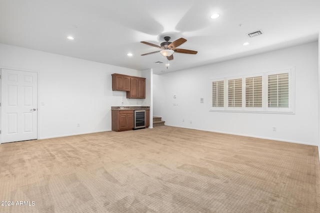 9845 E Inglewood St, Mesa, AZ 85207 - unfurnished living room with beverage cooler, recessed lighting, visible vents, and light colored carpet