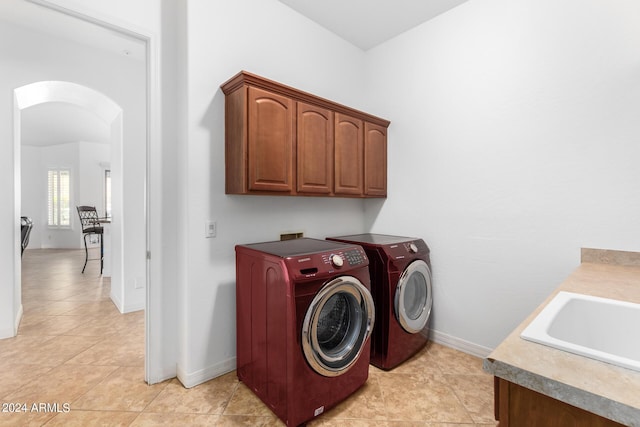 9845 E Inglewood St, Mesa, AZ 85207 - washroom featuring arched walkways, a sink, baseboards, cabinet space, and washer and clothes dryer