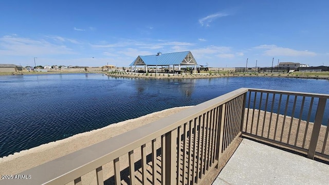 dock area with a balcony and a water view