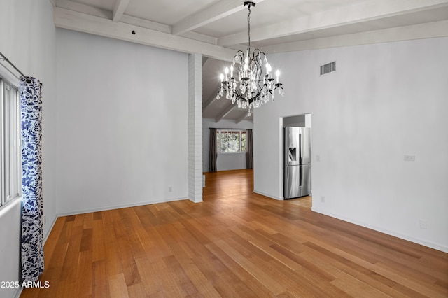 235 El Camino Grande, Sedona, AZ 86336 - unfurnished dining area with beamed ceiling, a chandelier, wood finished floors, and baseboards