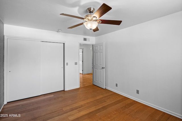 235 El Camino Grande, Sedona, AZ 86336 - unfurnished bedroom featuring wood finished floors, a closet, baseboards, and ceiling fan