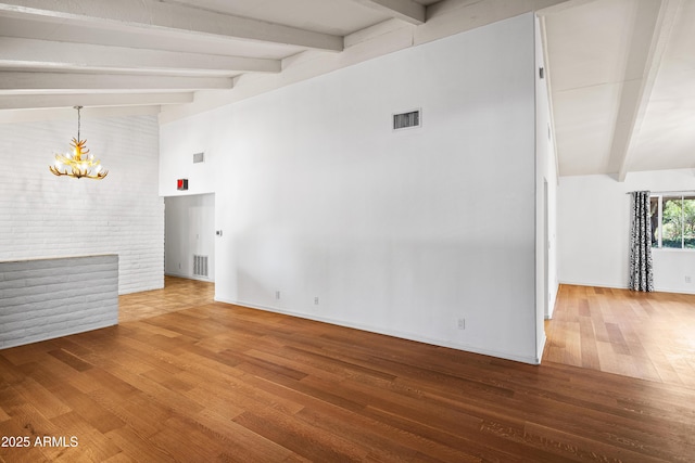 235 El Camino Grande, Sedona, AZ 86336 - unfurnished living room with beamed ceiling, a chandelier, wood finished floors, high vaulted ceiling, and baseboards