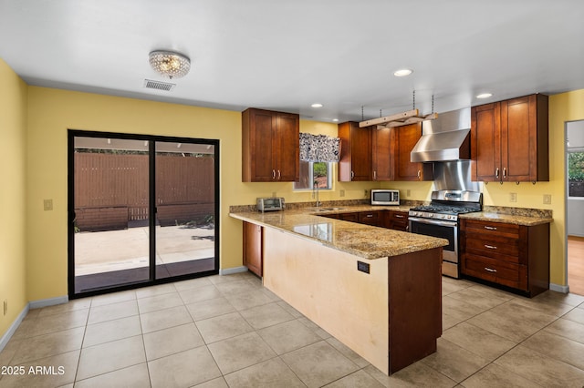 235 El Camino Grande, Sedona, AZ 86336 - kitchen featuring stainless steel appliances, wall chimney range hood, a peninsula, a sink, and recessed lighting