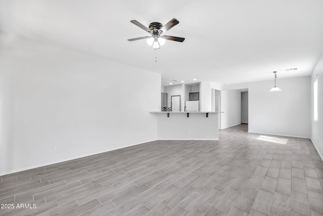 7207 W Alta Vista Rd, Laveen, AZ 85339 - unfurnished living room with ceiling fan, light wood-style flooring, and recessed lighting