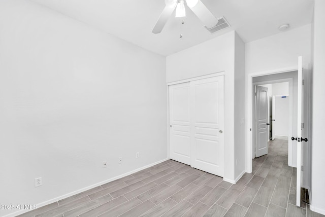 7207 W Alta Vista Rd, Laveen, AZ 85339 - unfurnished bedroom featuring light wood finished floors, a closet, and ceiling fan