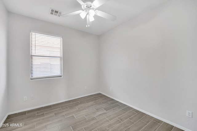7207 W Alta Vista Rd, Laveen, AZ 85339 - spare room featuring wood finished floors, healthy amount of natural light, and a ceiling fan