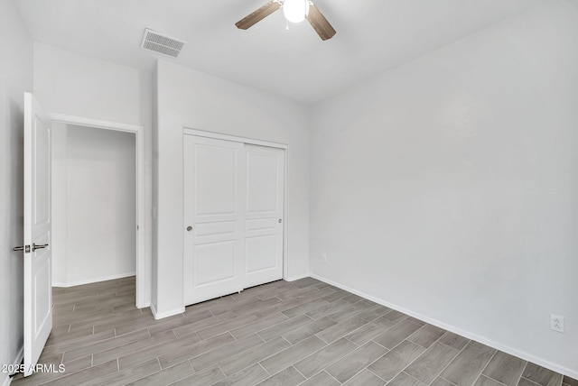 7207 W Alta Vista Rd, Laveen, AZ 85339 - unfurnished bedroom featuring light wood-style flooring, a closet, and ceiling fan