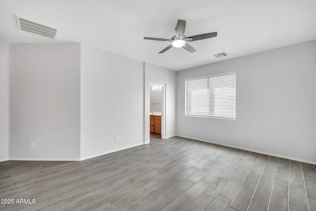 7207 W Alta Vista Rd, Laveen, AZ 85339 - empty room with light wood-style floors and ceiling fan