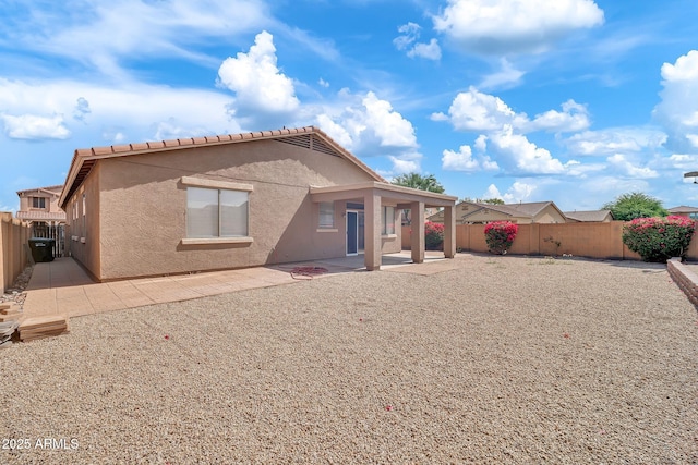 7207 W Alta Vista Rd, Laveen, AZ 85339 - back of property with stucco siding, a fenced backyard, a patio, and a tile roof