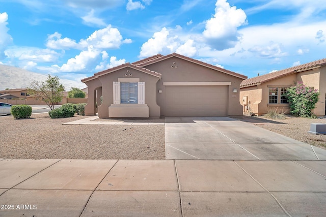 7207 W Alta Vista Rd, Laveen, AZ 85339 - mediterranean / spanish-style home featuring stucco siding, driveway, a garage, and a tile roof