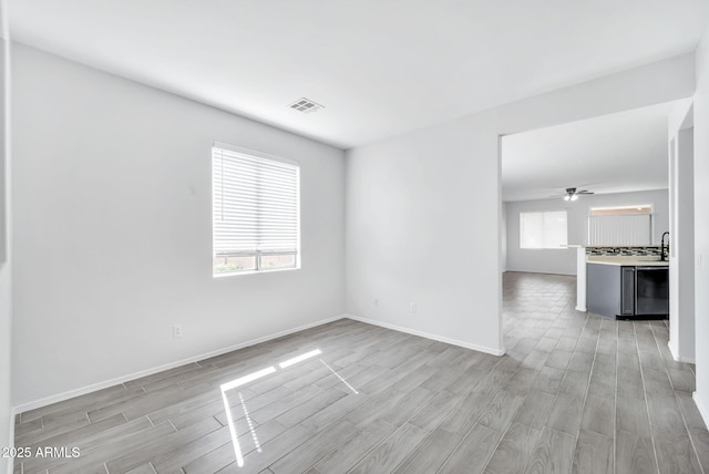 7207 W Alta Vista Rd, Laveen, AZ 85339 - unfurnished room featuring light wood-style flooring and ceiling fan