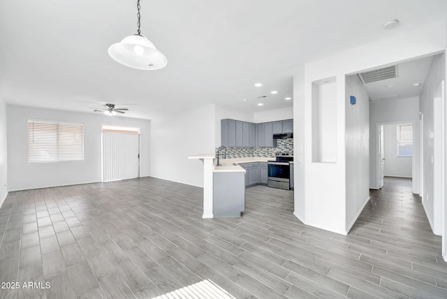 7207 W Alta Vista Rd, Laveen, AZ 85339 - kitchen featuring stainless steel electric range, gray cabinetry, open floor plan, healthy amount of natural light, and recessed lighting
