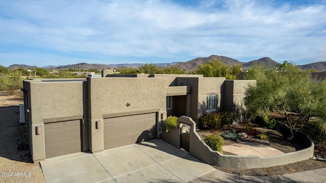 pueblo-style house with a mountain view and a garage