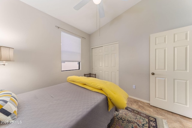 bedroom featuring ceiling fan, vaulted ceiling, and a closet