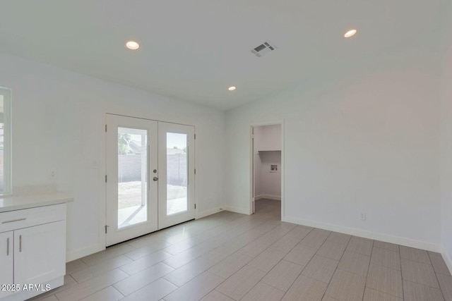 unfurnished room featuring recessed lighting, french doors, visible vents, and baseboards