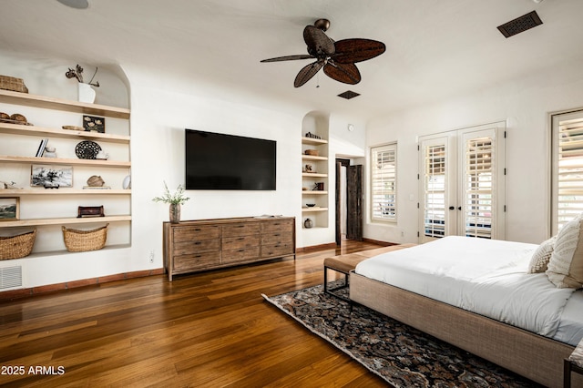 bedroom with visible vents, access to exterior, wood finished floors, and multiple windows