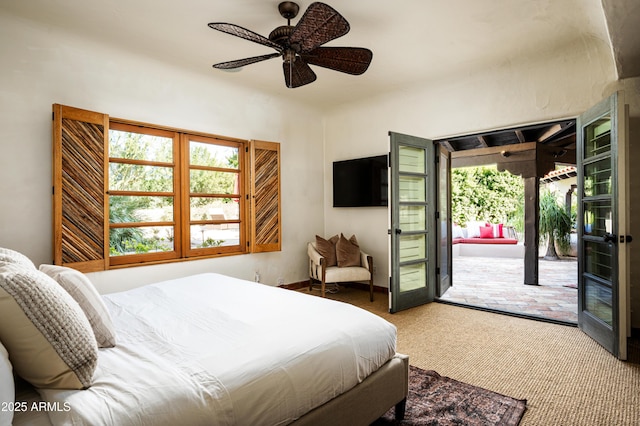 carpeted bedroom with a ceiling fan and access to outside